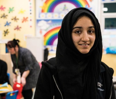 student in foreground of early years setting