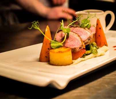 Meat and vegetables beautifully presented on a plate