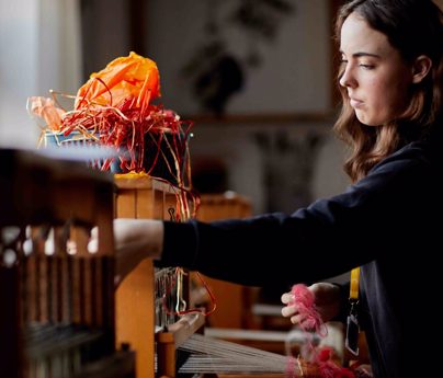 Female student organising her textile work station