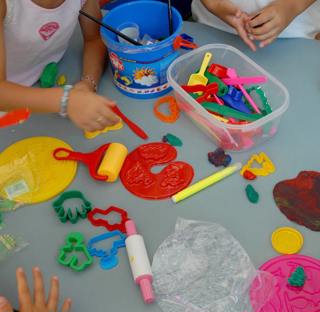 children playing with play dough moulds and cutters