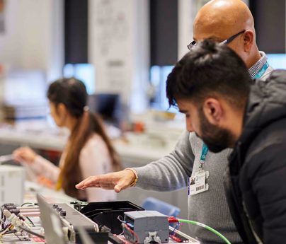 tutor shows student electrical components