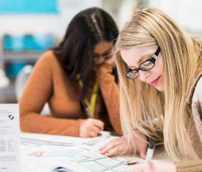 students working at table with open textbooks