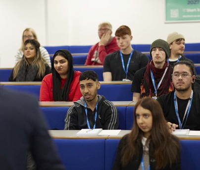 student sat in rows of lecture theatre