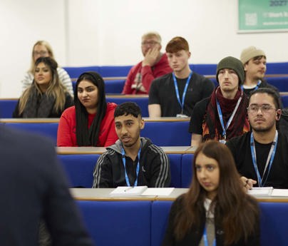 student sat in rows of lecture theatre 