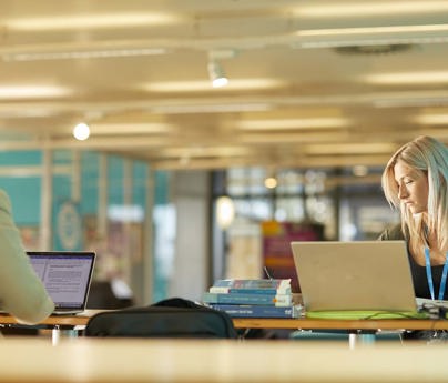 Two students studying in a communal space.