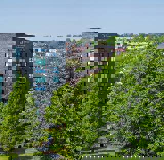 Blackburn College campus with Beacon Centre, University Centre and large leafy trees