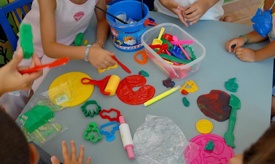 children playing with play dough moulds and cutters